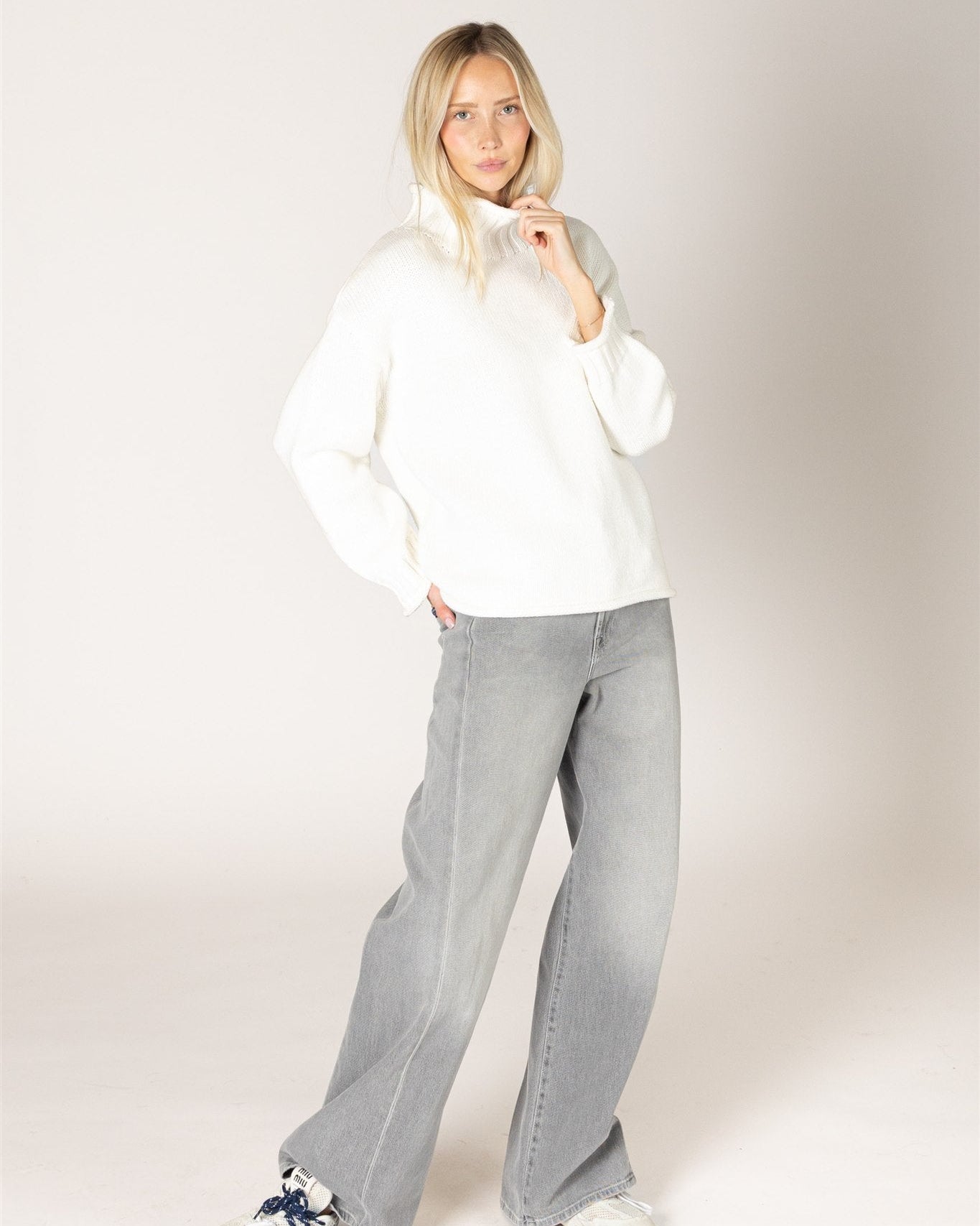 grey cardigan with ruffles down the middle and on sleeves