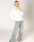 grey cardigan with ruffles down the middle and on sleeves