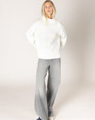 grey cardigan with ruffles down the middle and on sleeves