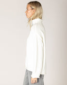 grey cardigan with ruffles down the middle and on sleeves