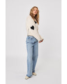 cream sweater with black heatrs all over