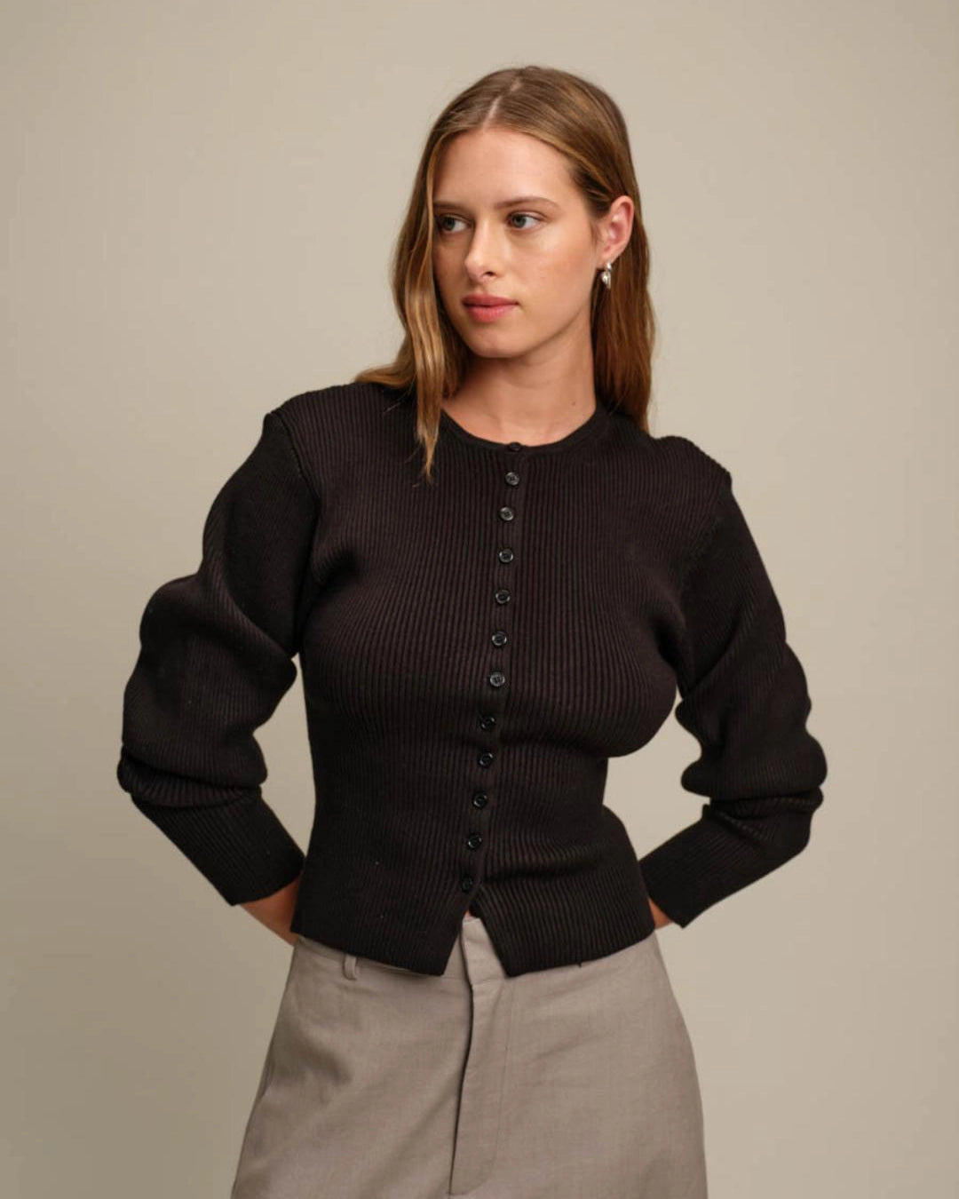 Woman wearing a black ribbed button down cardigan