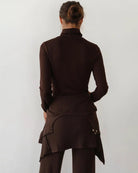 Woman wearing a brown turtleneck rib top 