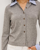 grey cardigan with blue and white stripe blouse collar and cuff