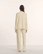 Woman wearing a light yellow pajama set 
