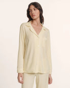 Woman wearing a light yellow pajama set 
