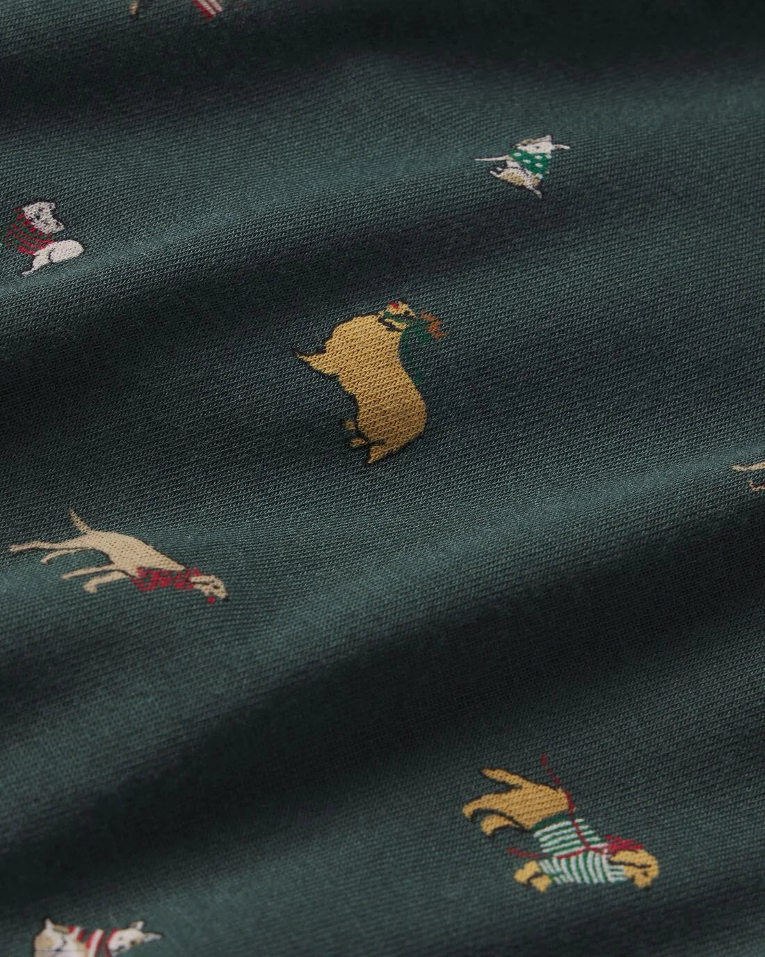 a dark green fabric with a holiday dog pattern 