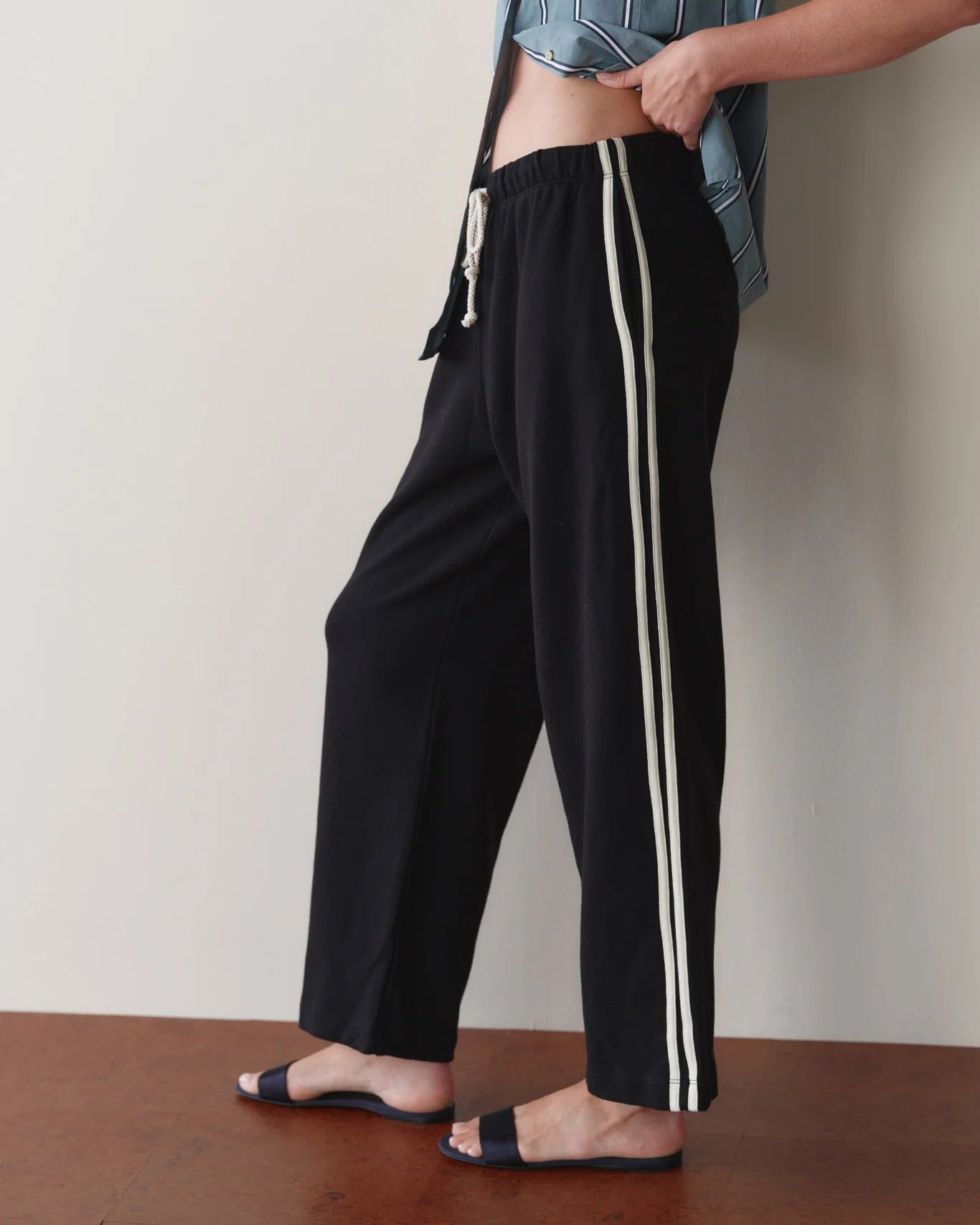 cropped lounge pant in black with white stripe down the sides 