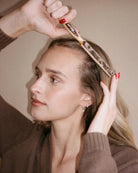 styling brush with a brown marble design on the back by Emi Jay