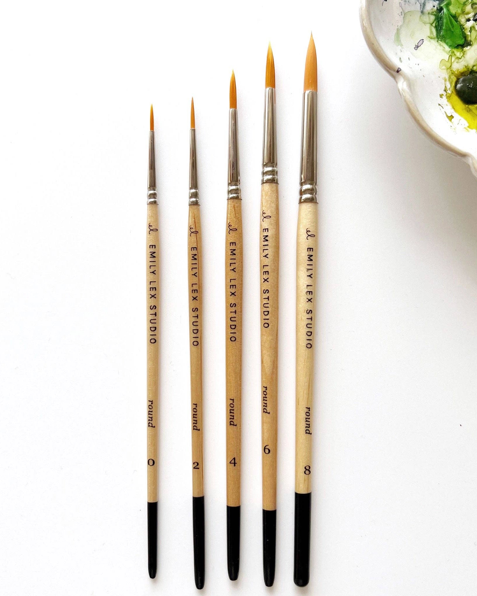 Watercolour paintbrushes with wooden handle with 'Emily Lex Studio' on them