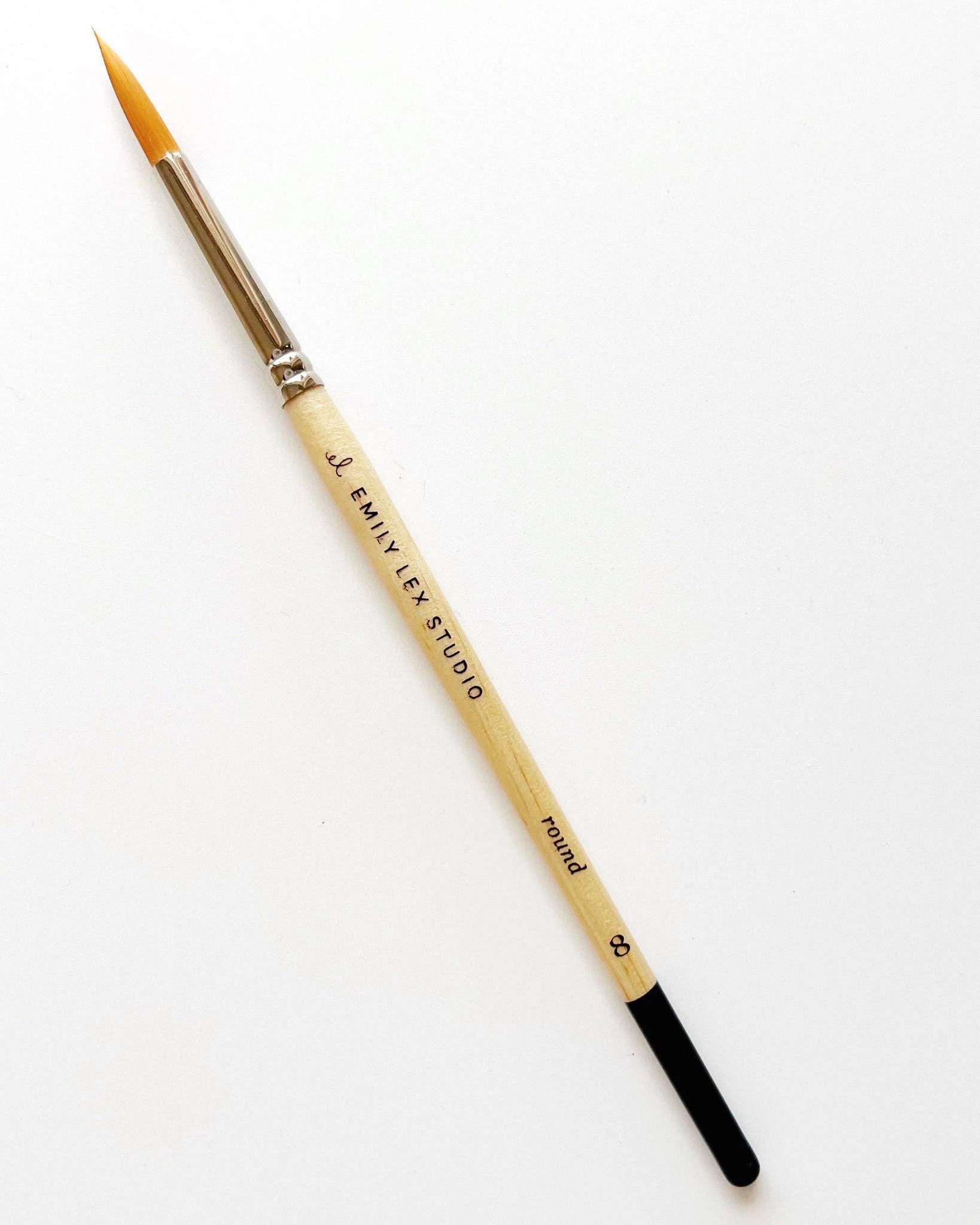 Watercolour paintbrush with wooden handle with 'Emily Lex Studio' on it