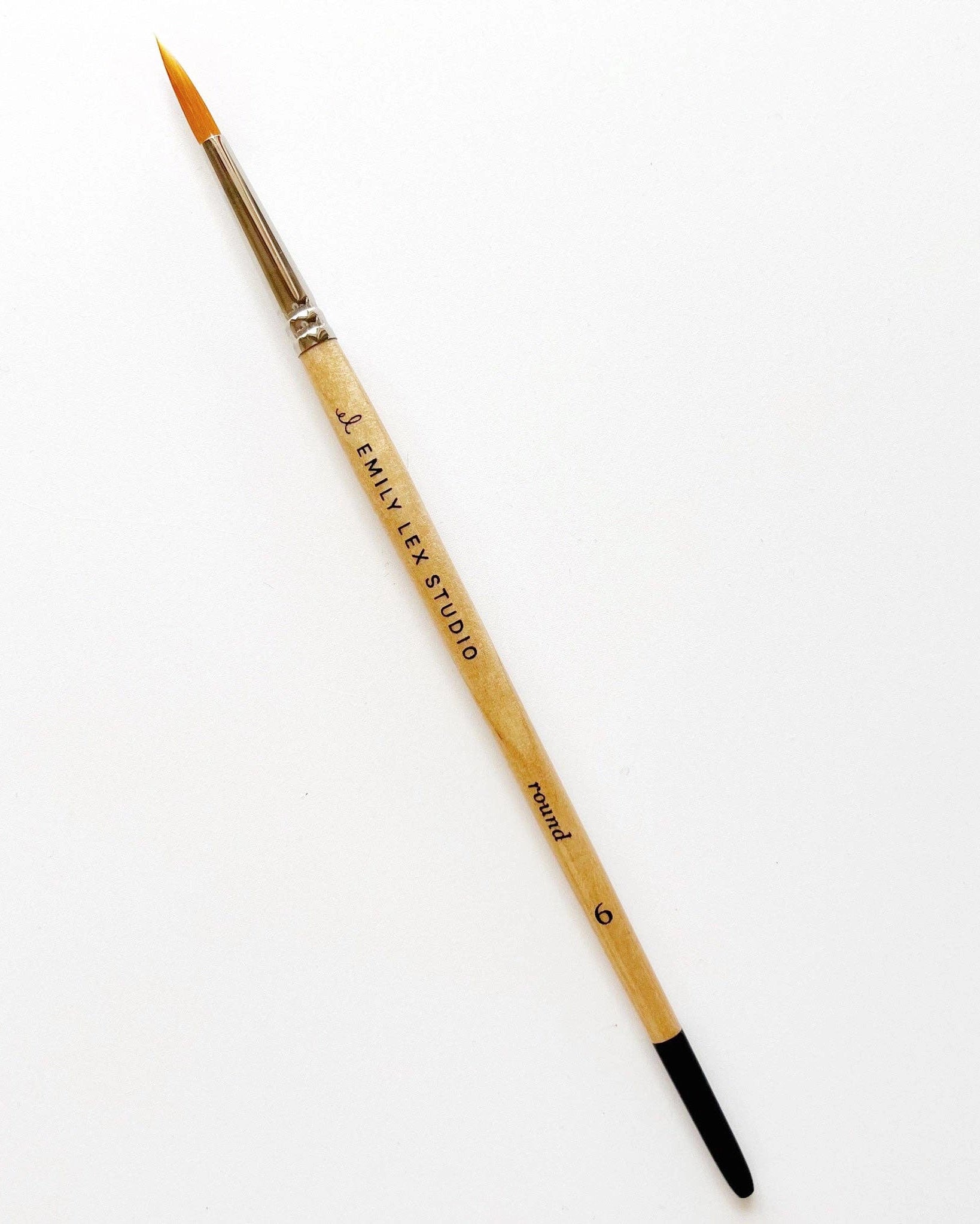 Watercolour paintbrush with wooden handle with 'Emily Lex Studio' on it