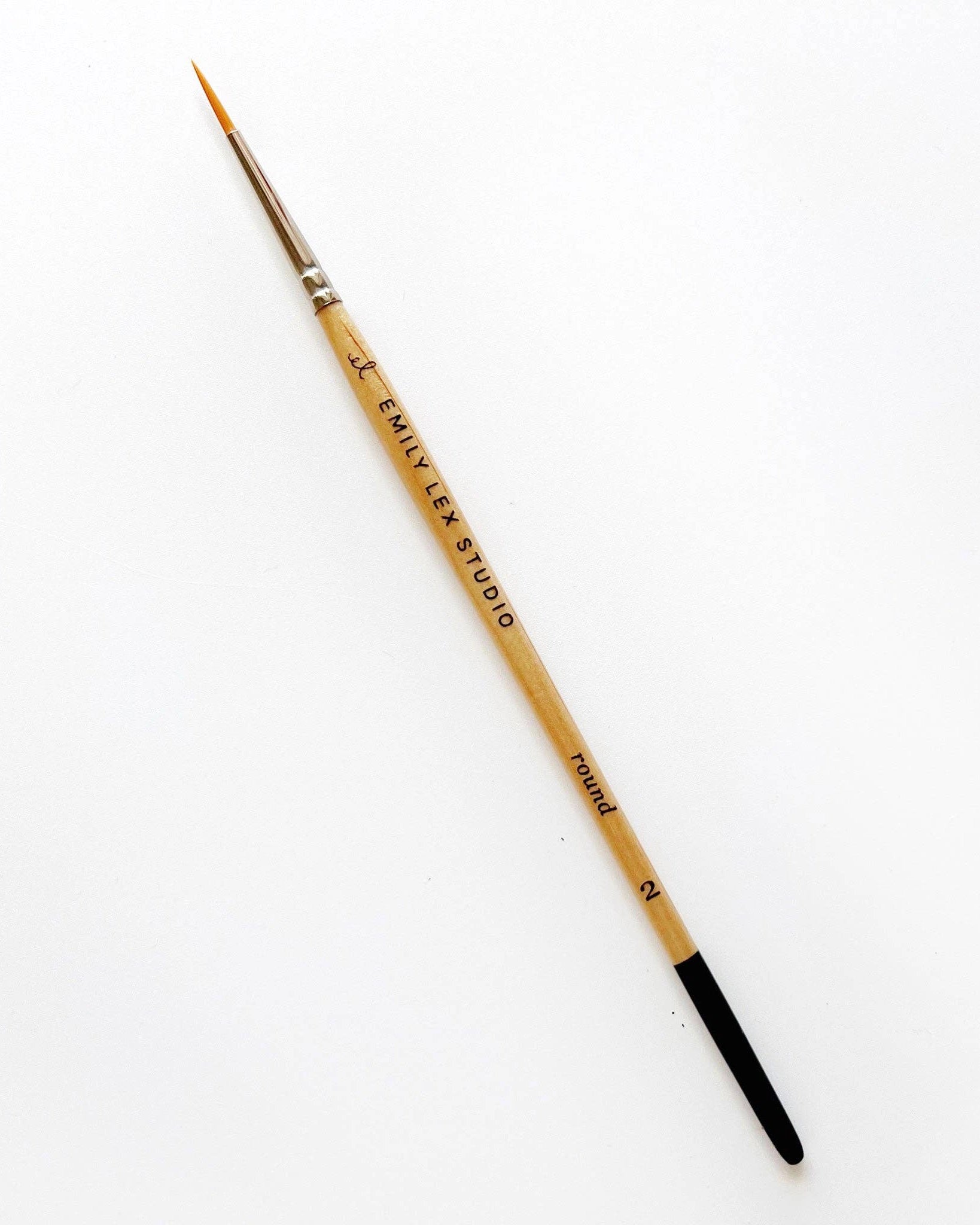 Watercolour paintbrush with wooden handle with 'Emily Lex Studio' on it