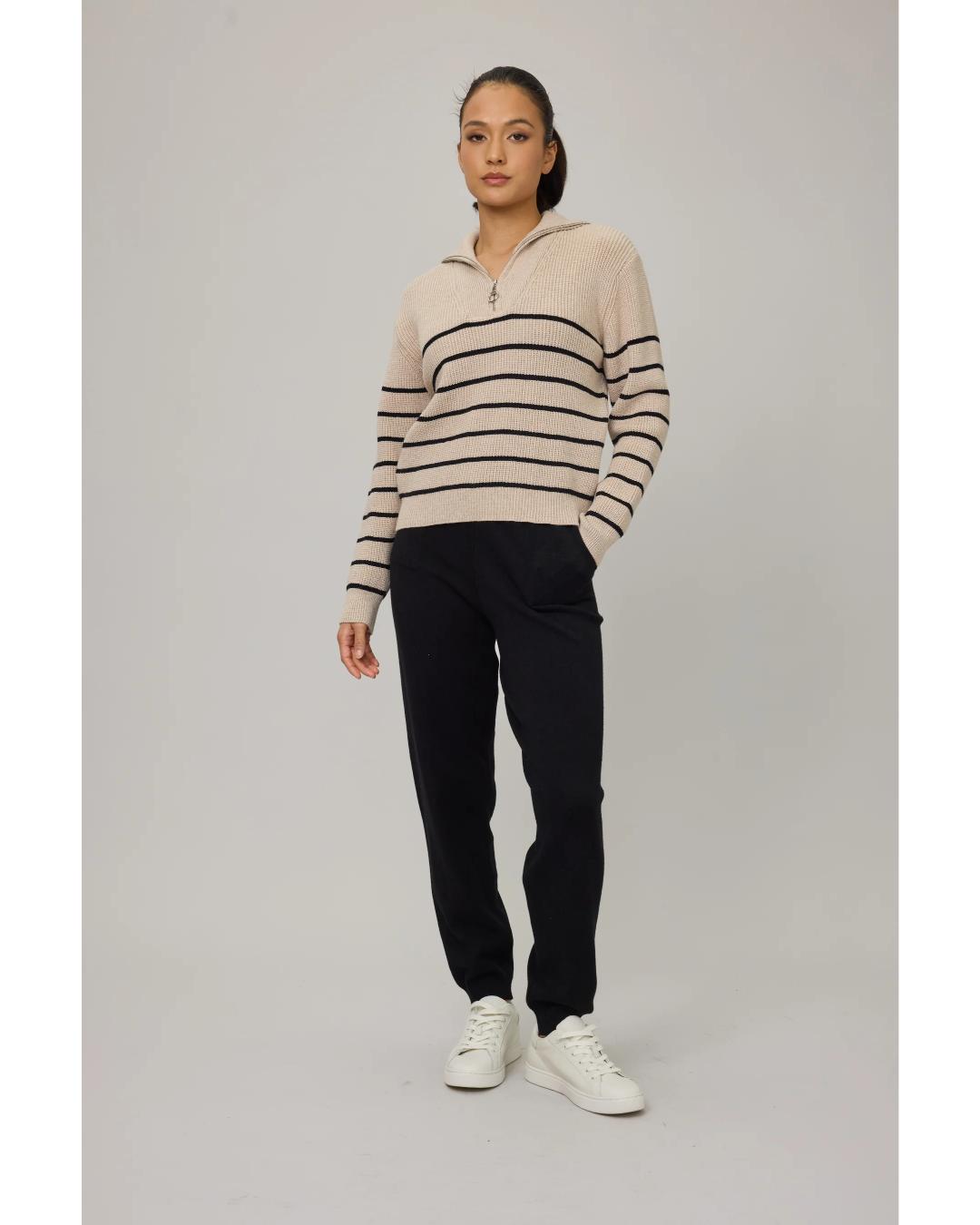 beige sweater with black stripes and a half zip