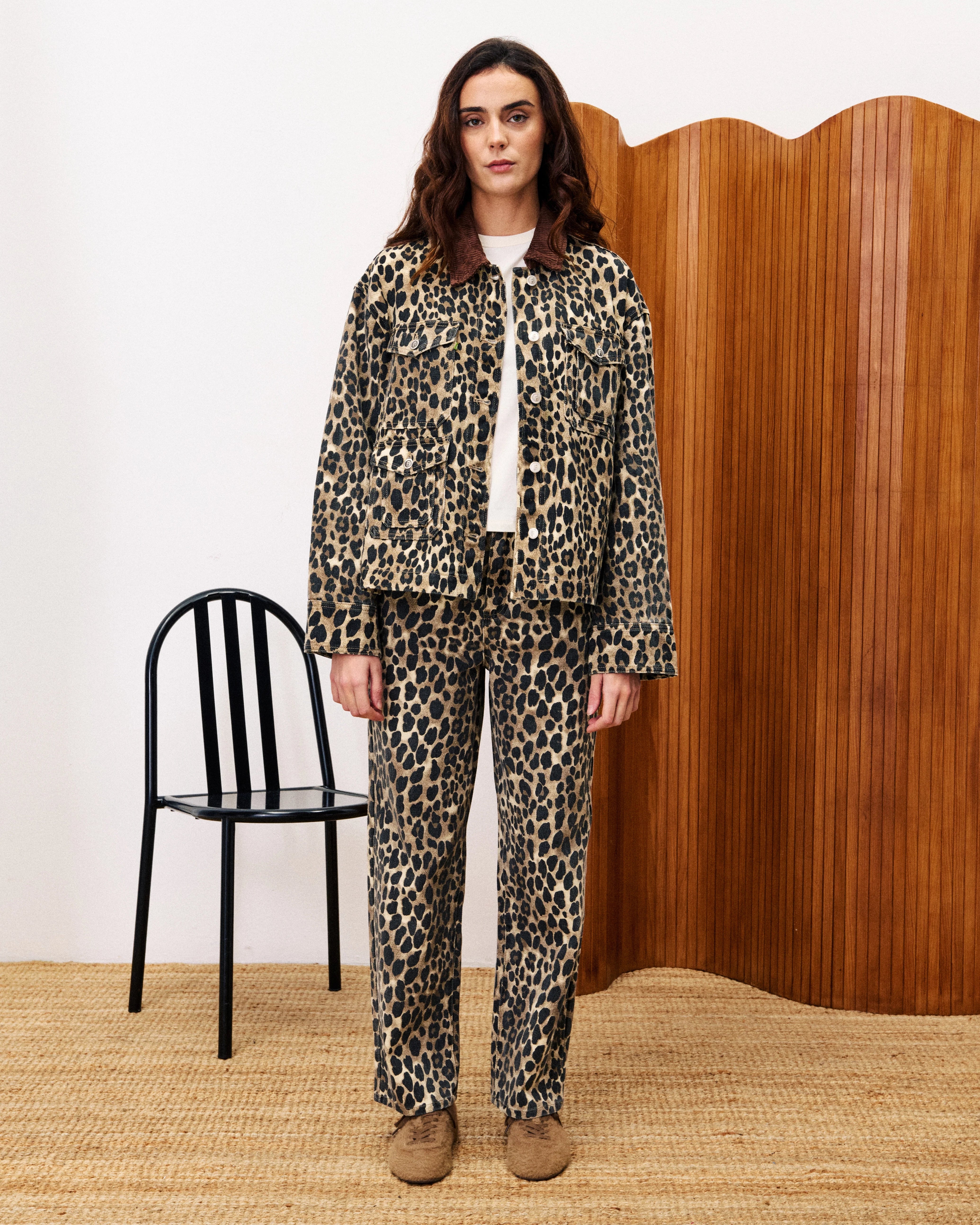 woman wearing a leopard print denim jacket and matching pants