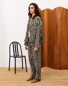 woman wearing a leopard print denim jacket and matching pants