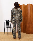 woman wearing a leopard print denim jacket and matching pants