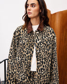 woman wearing a leopard print denim jacket