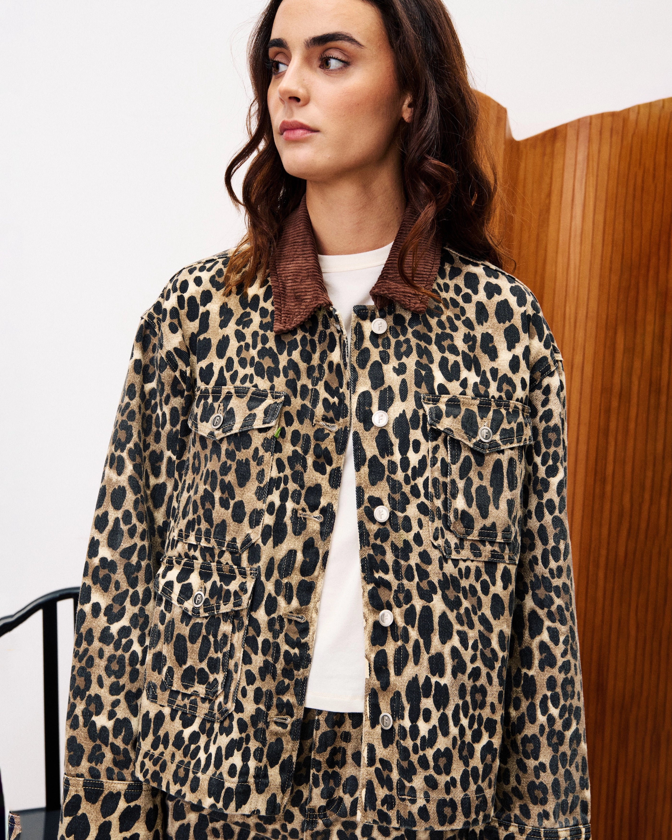 woman wearing a leopard print denim jacket