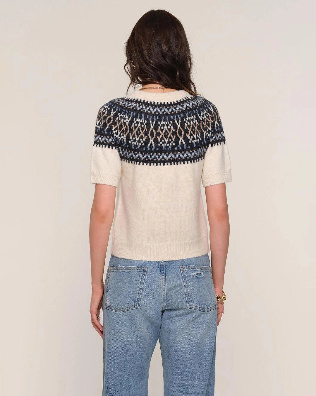 a woman wears a fairisle patterned sweater knit tee