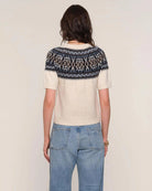 a woman wears a fairisle patterned sweater knit tee