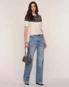 a woman wears a fairisle patterned sweater knit tee