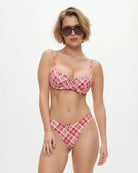Woman wearing a red plaid bikini from Frankies Bikinis