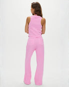 a woman is wearing waffle knit joggers in neon pink by Frankies Bikinis