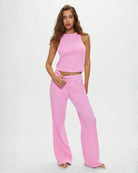 a woman wears a waffle knit tank top in neon pink by Frankie Bikinis