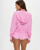 a woman wears a waffle knit neon pink zipper hoodie by Frankies Bikinis