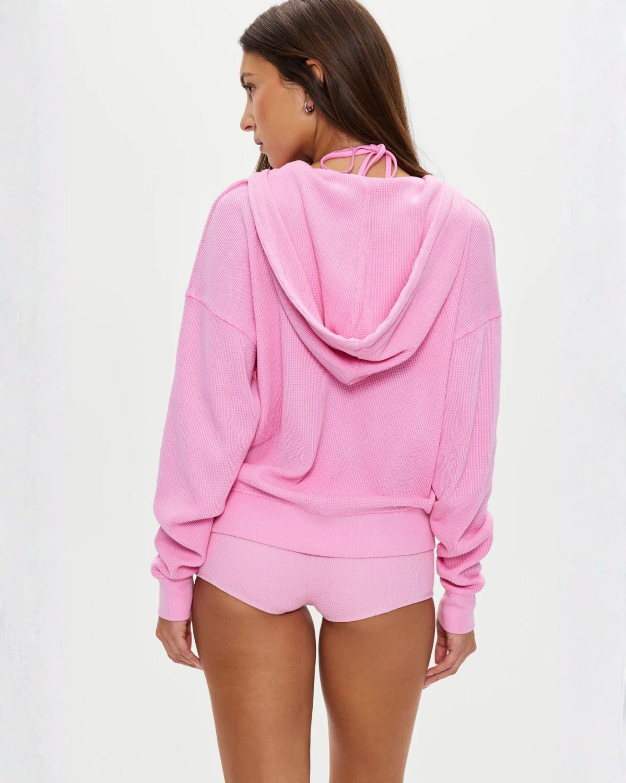 a woman wears a waffle knit neon pink zipper hoodie by Frankies Bikinis