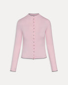 Woman wearing a pink ribbed long-sleeve button down top with grey trim