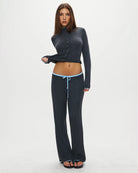 a woman wears a dark grey ribbed lounge pants with light blue drawstring