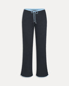 a woman wears a dark grey ribbed lounge pants with light blue drawstring