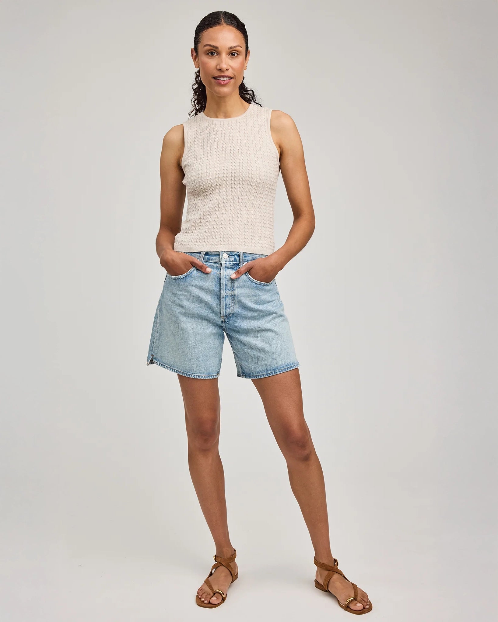 Woman wearing a beige sleeveless knitted top by Gentle Dawn