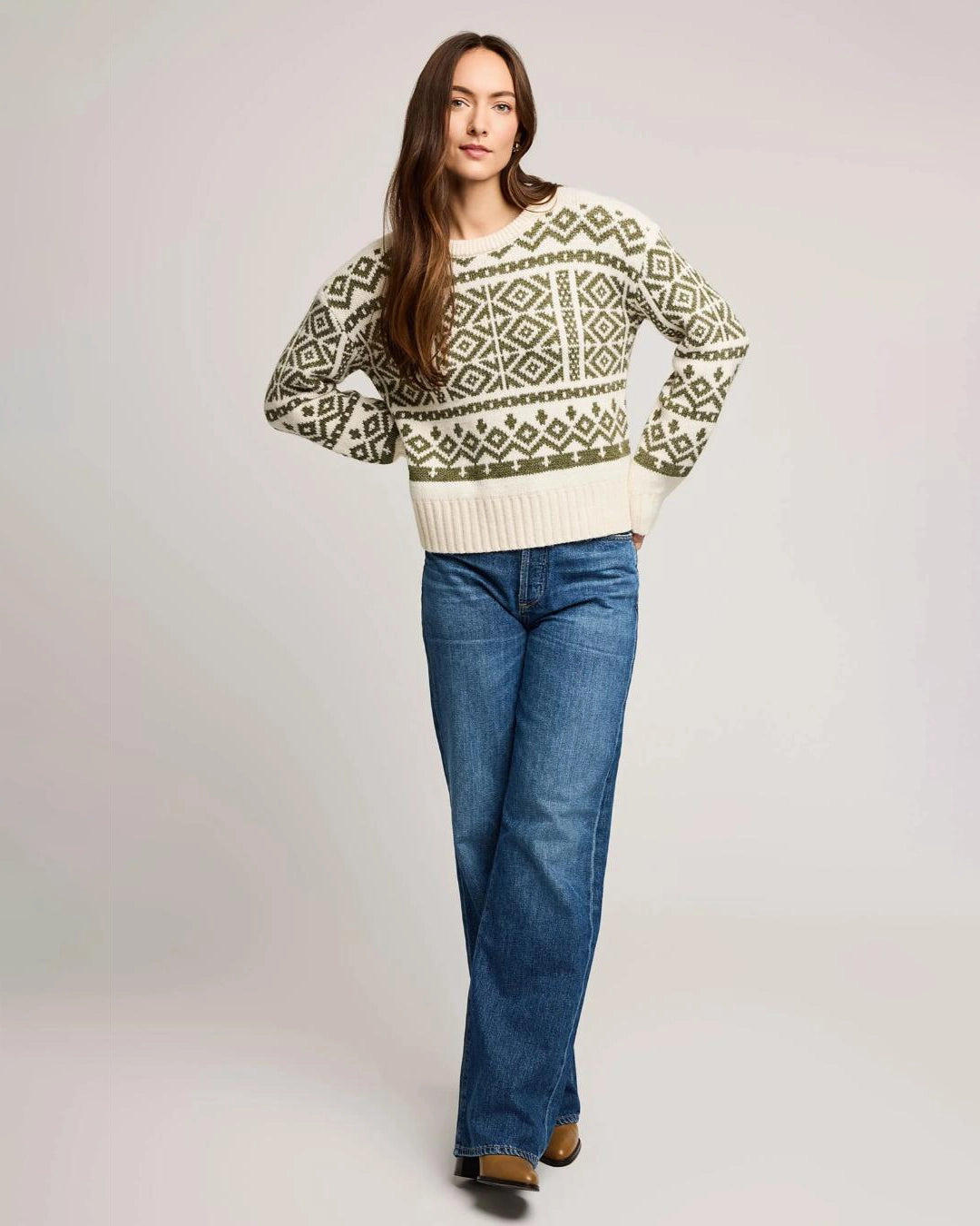woman wearing a geometric fairisle holiday sweater in cream and green