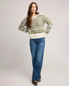 woman wearing a geometric fairisle holiday sweater in cream and green