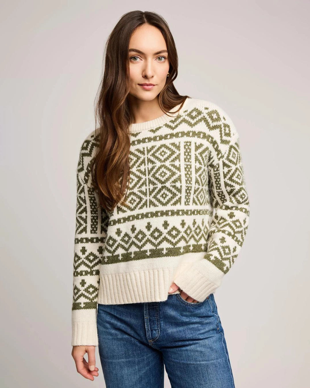 woman wearing a geometric fairisle holiday sweater in cream and green