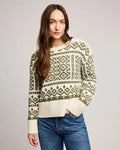 woman wearing a geometric fairisle holiday sweater in cream and green
