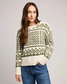 woman wearing a geometric fairisle holiday sweater in cream and green