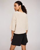 woman wearing beige knit sweater by Gentle Fawn