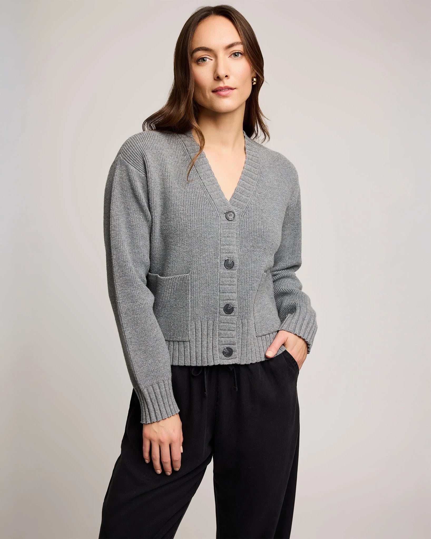 Woman wearing a gray knit button down cardigan