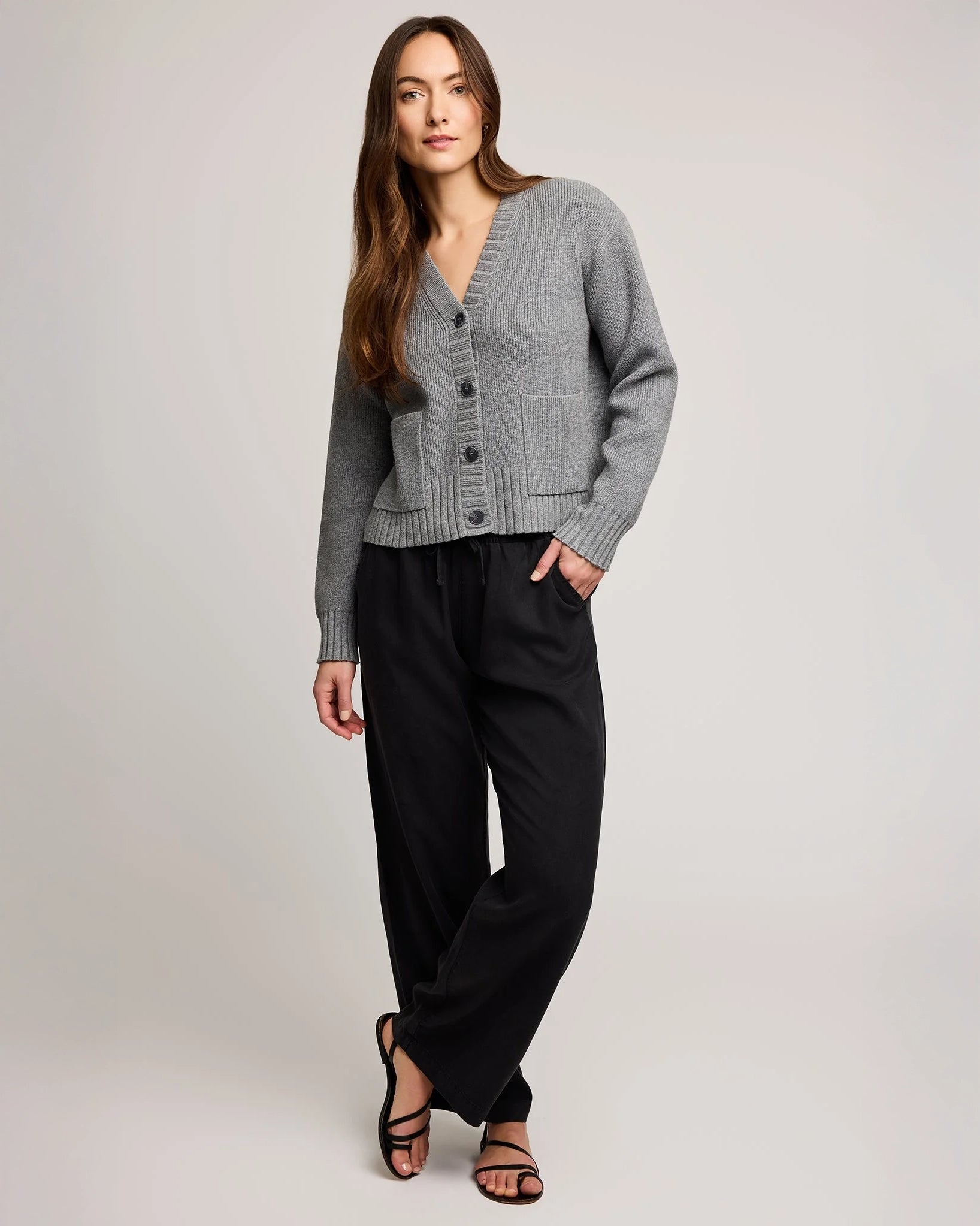 Woman wearing a gray knit button down cardigan