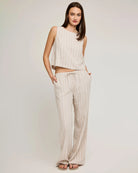 Woman wearing a linen stripe sleeveless top and pants