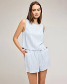 Woman wearing a blue stripe sleeveless top and shorts