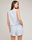 Woman wearing a blue stripe sleeveless top and shorts