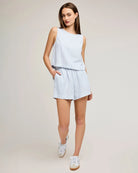 Woman wearing a blue stripe sleeveless top and shorts