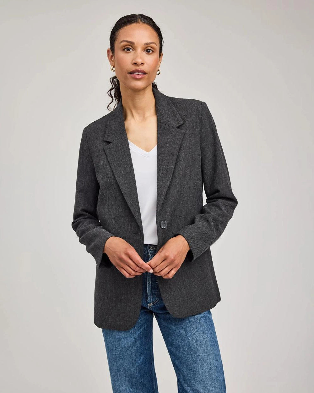 Woman wearing a gray blazer with one single button