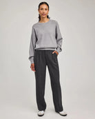 woman wearing grey tailored pants wth center pleat