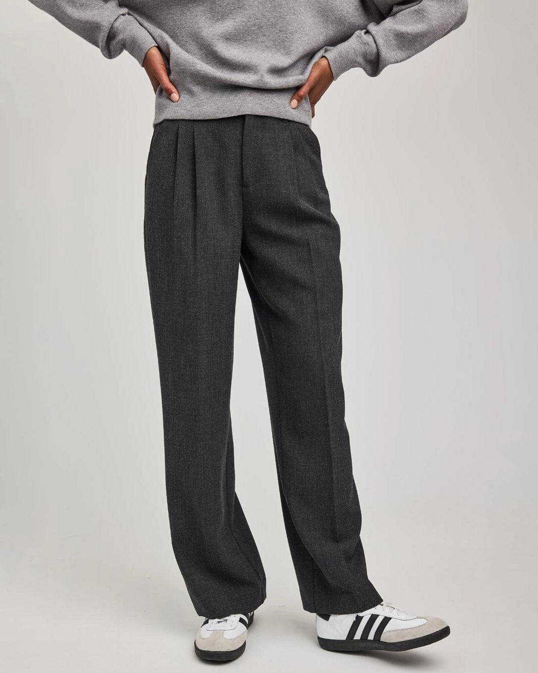 woman wearing grey tailored pants wth center pleat